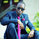 Chris Smith a.k.a. CLS, at a photo shoot wearing navy blue suit in an Instagram post.